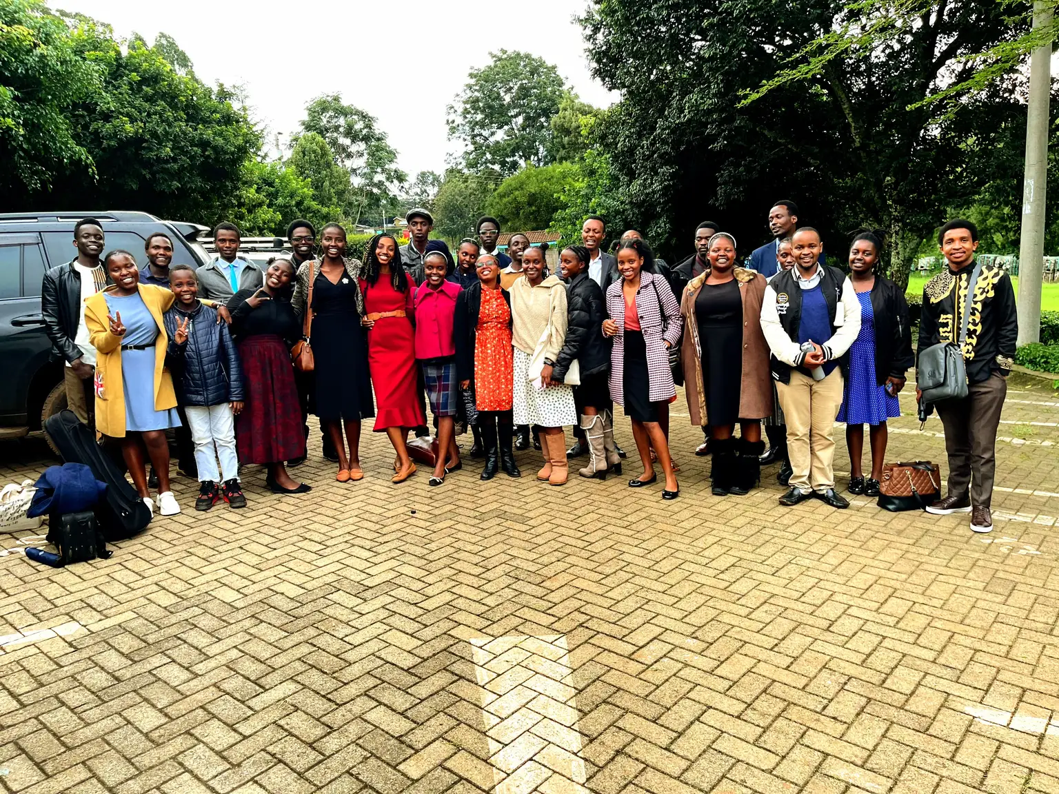 Imara Chorale members standing together outdoors among trees, dressed for Sabbath